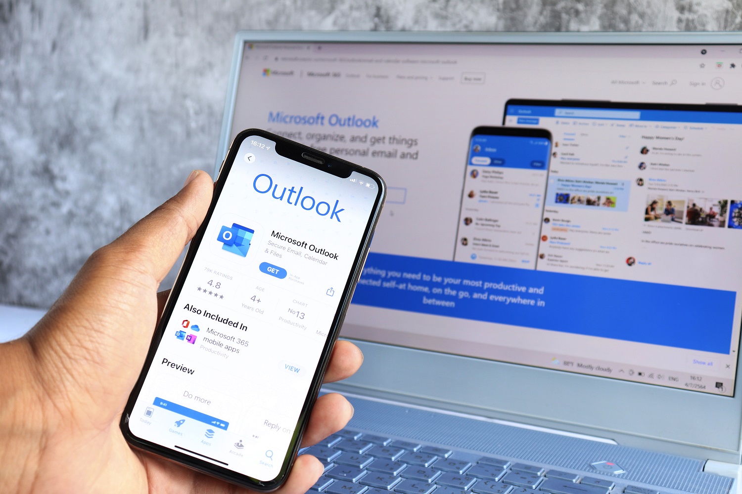Microsoft Outlook on computer screen and Microsoft Outlook logo